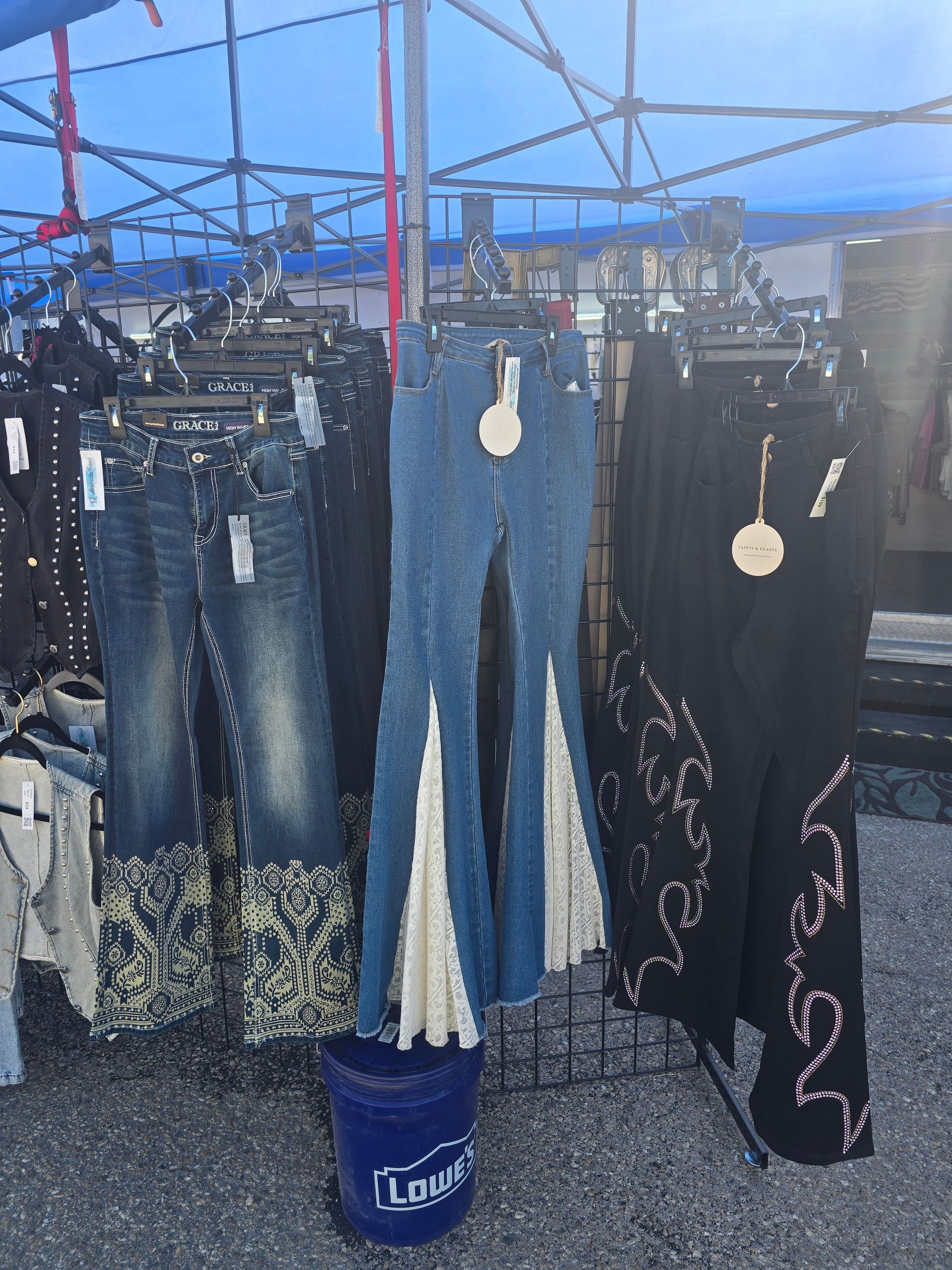 Clothing display featuring denim jeans with decorative accents.