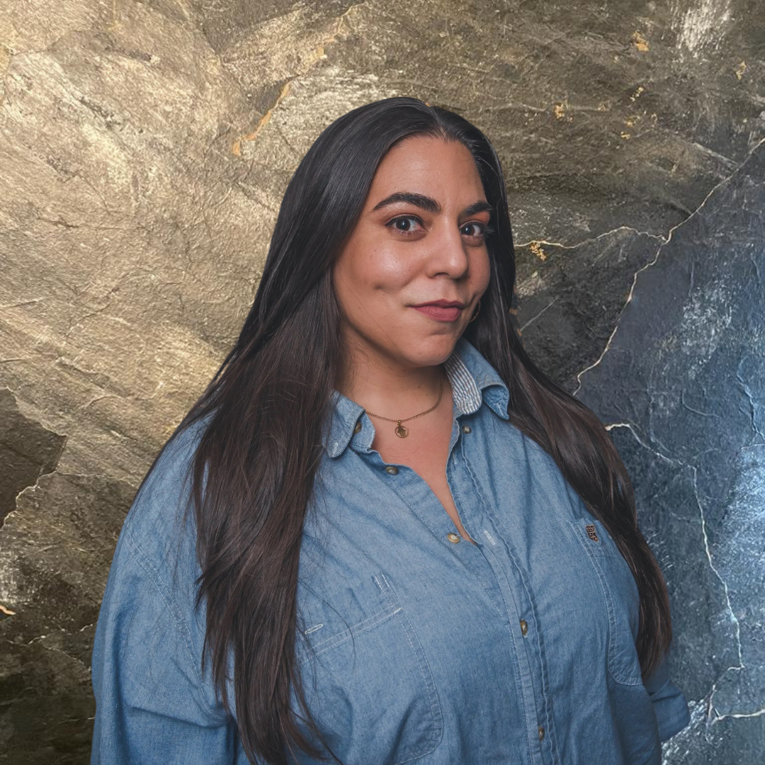 a woman with long hair wearing a denim shirt