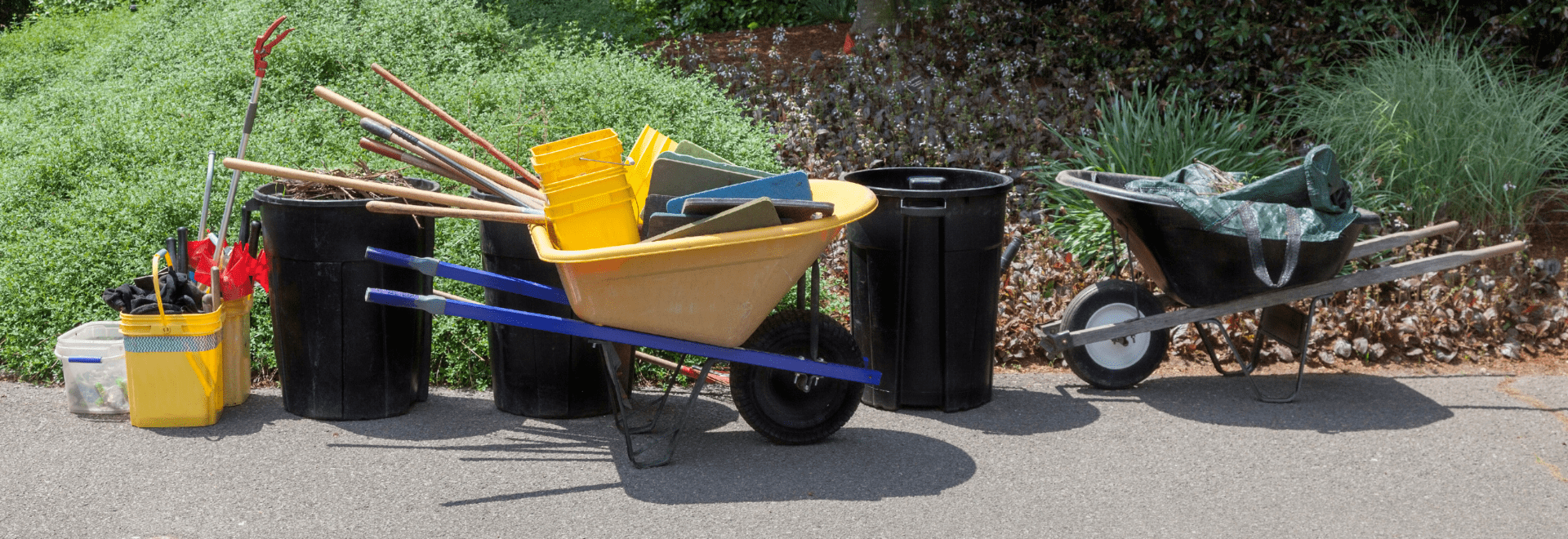 Landscaping tools and equipment in wheelbarrows and bins, from Boise Landscaping Company