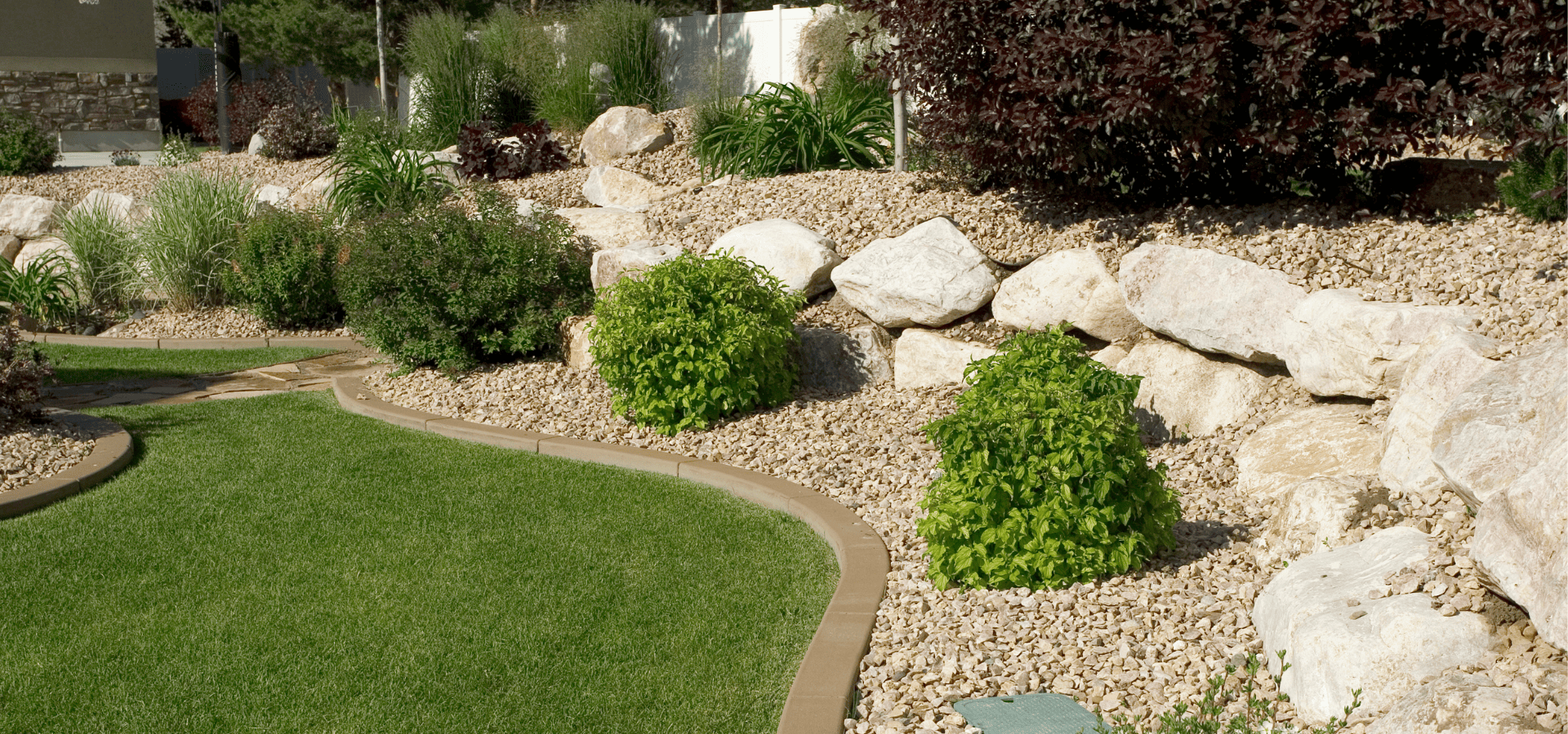 A sustainable landscape with native plants and filled with more gravel for lower maintenance