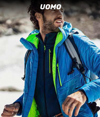 A man wearing a blue jacket and a backpack is standing in the snow.