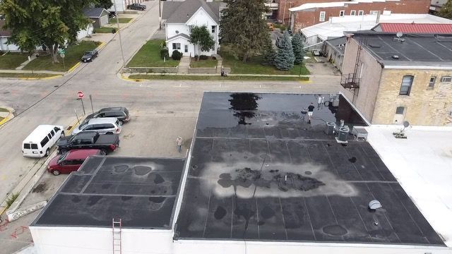 An aerial view of a building with a black roof