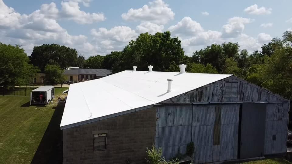 An aerial view of a building with a white roof.