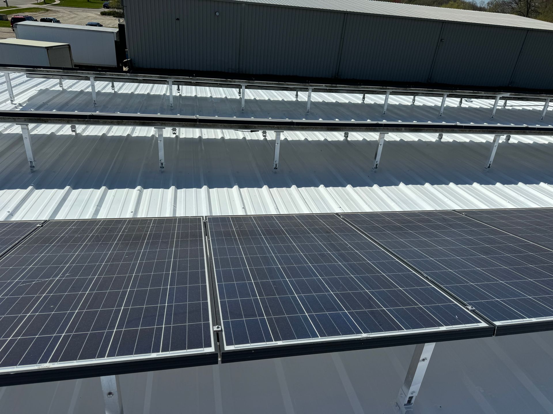 A row of solar panels on the roof of a building