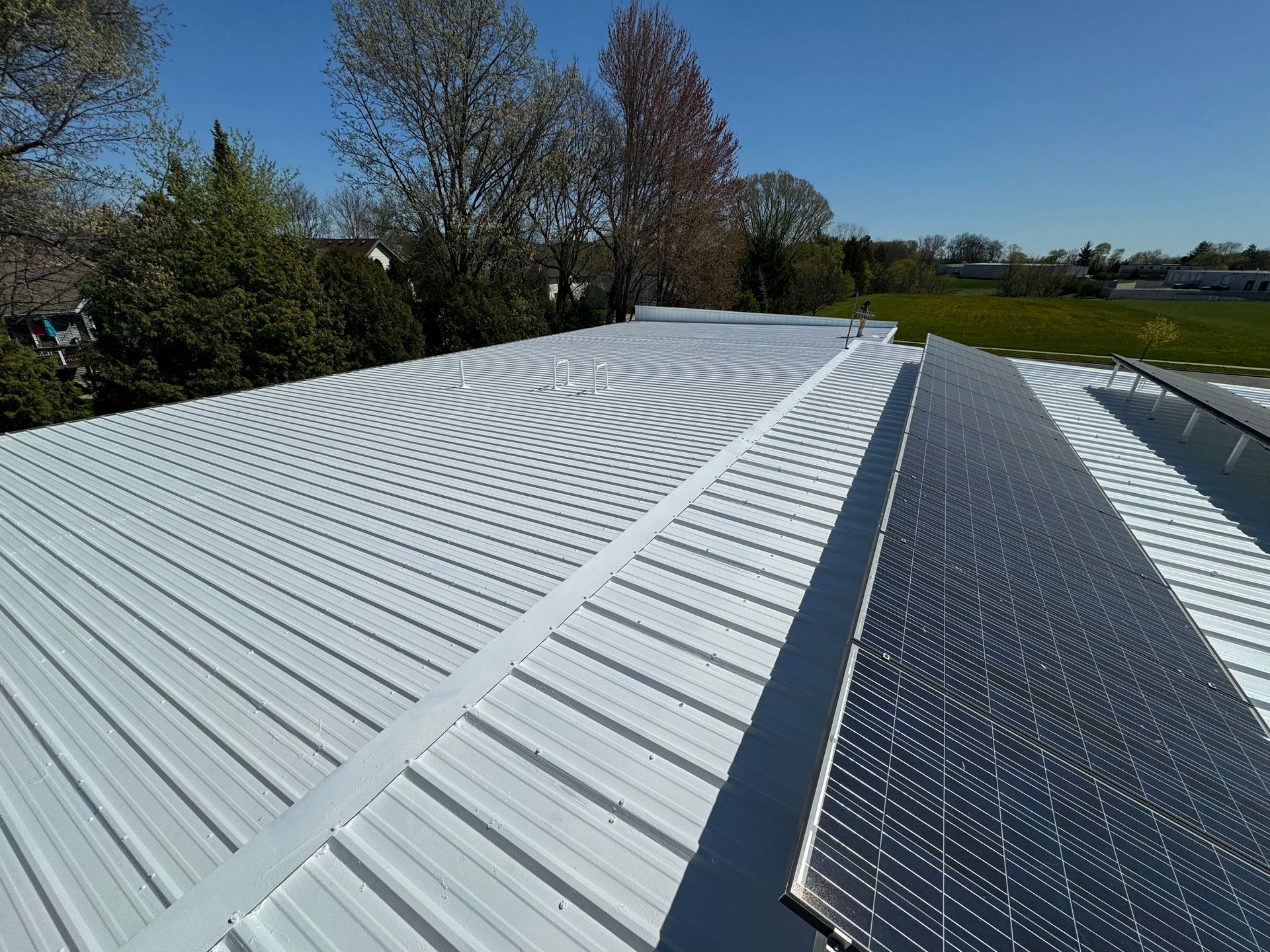 A white roof with a solar panel on top of it