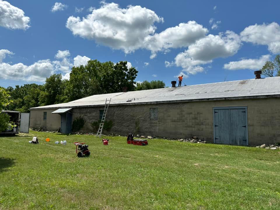 A man is standing on the roof of a building.