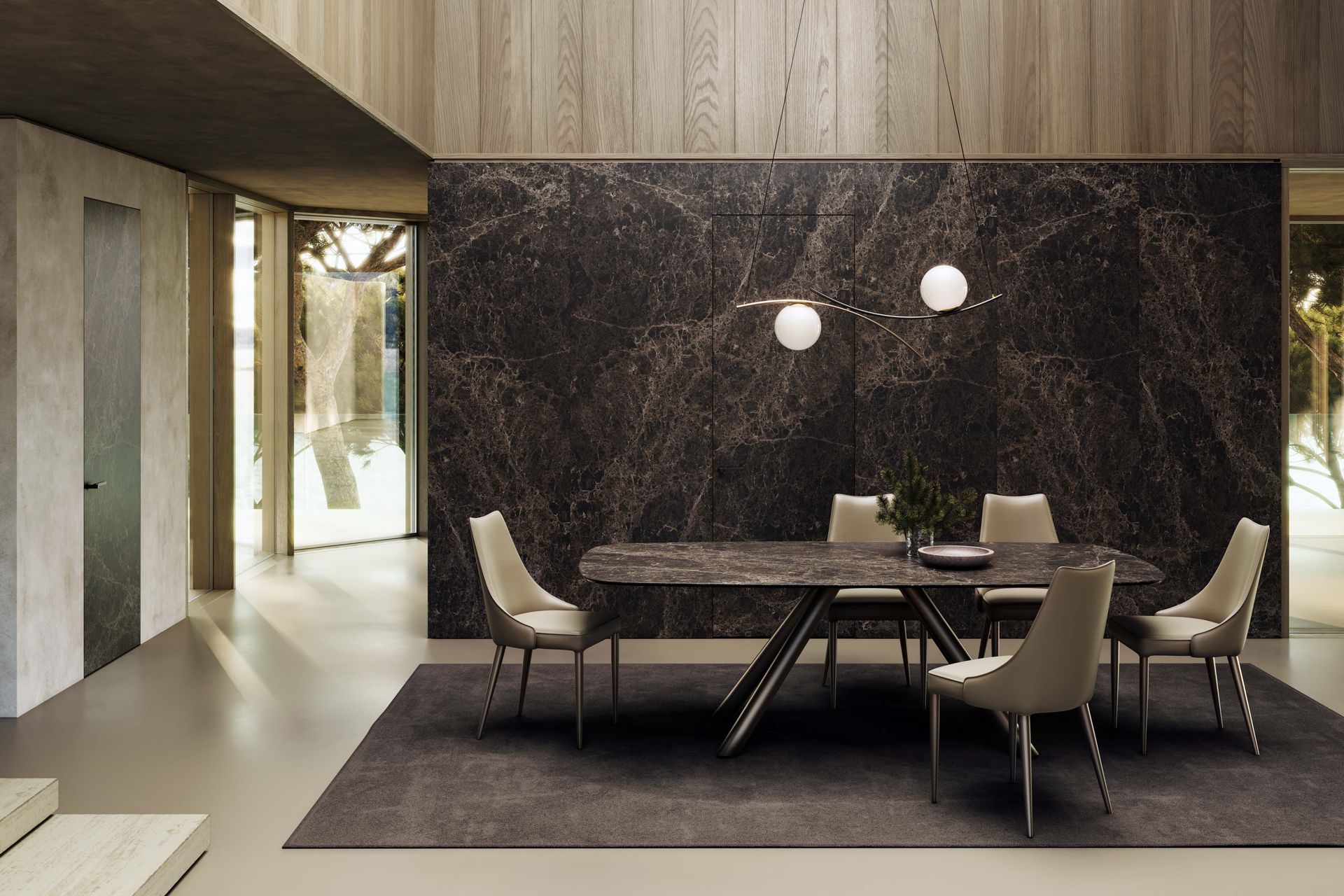 Sala da pranzo con un lungo tavolo, sedie e una parete con motivi scuri.
