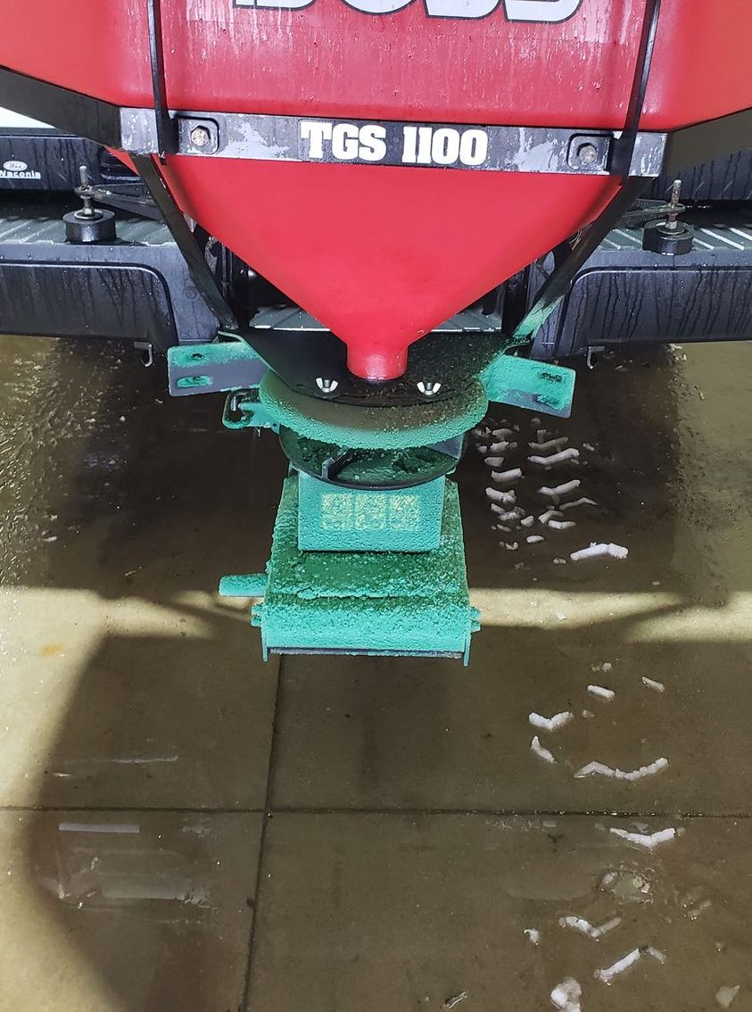 a red boat is sitting in a puddle of water .