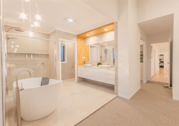 A bathroom with a bathtub, sinks and a walk in shower.