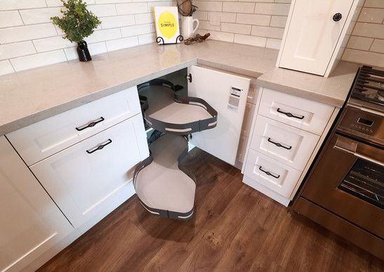 A kitchen with white cabinets and a stainless steel stove.