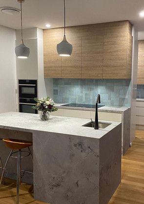 A kitchen with a large island and a sink.