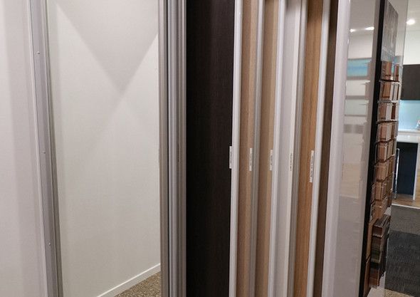 A row of wooden frames are lined up next to each other in a room.