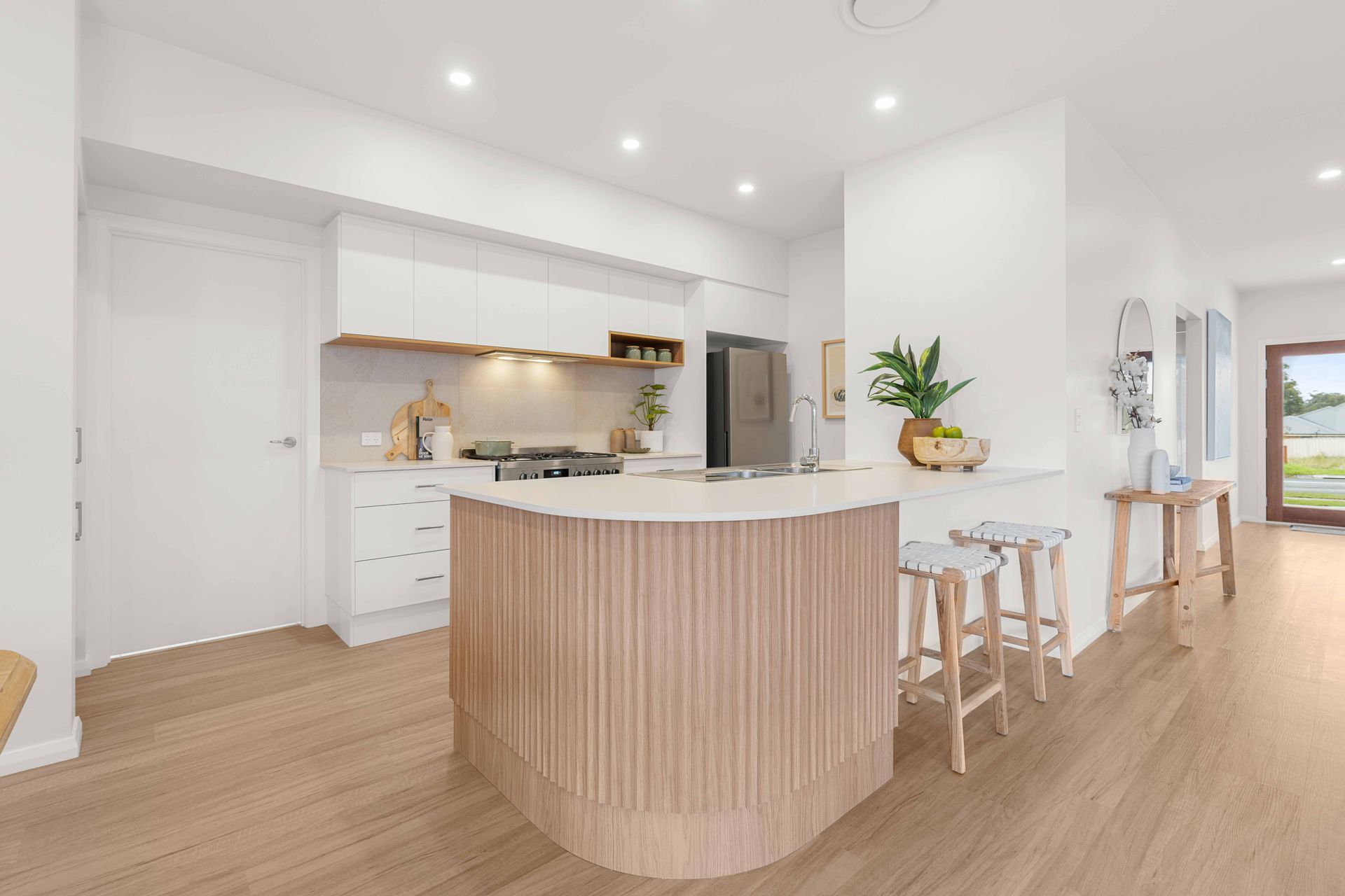 A kitchen with a long island and wicker stools. A kitchen with a long island and wicker stools.