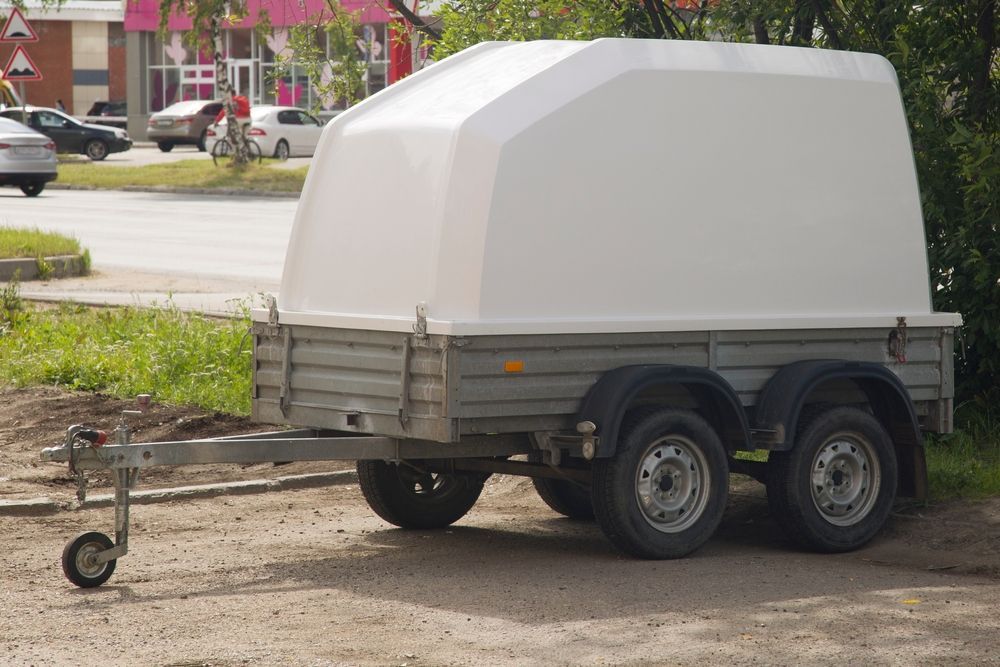 White-topped Trailer Parked On Gravel, With Three Wheels Visible — Soward Steel & Aluminium Fabrication in South Lismore, NSW