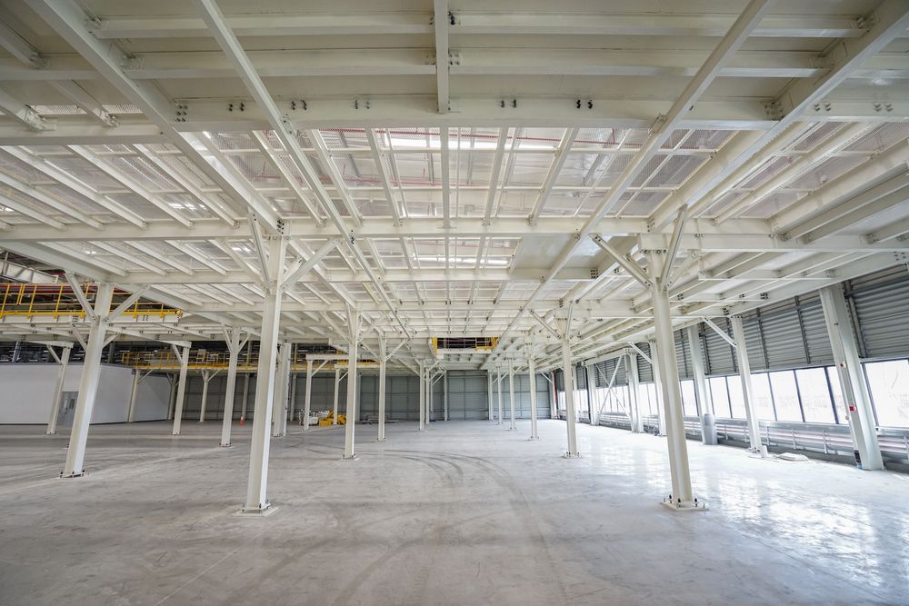 Interior View Of A Large Industrial Building With White Support Beams — Soward Steel & Aluminium Fabrication in Ballina, NSW