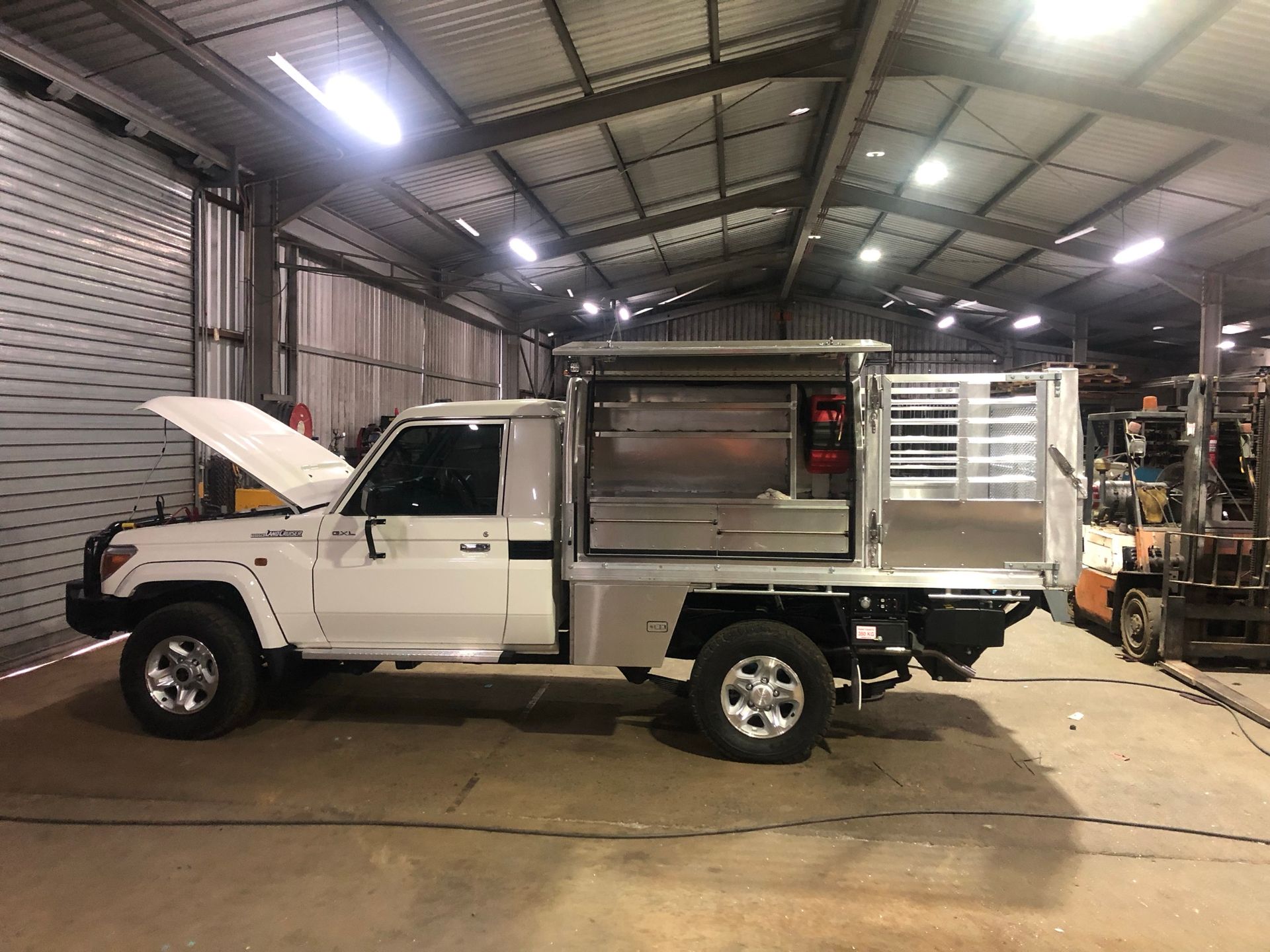 Pickup Truck With Custom Aluminum Utility Bed Inside A Workshop — Soward Steel & Aluminium Fabrication in South Lismore, NSW