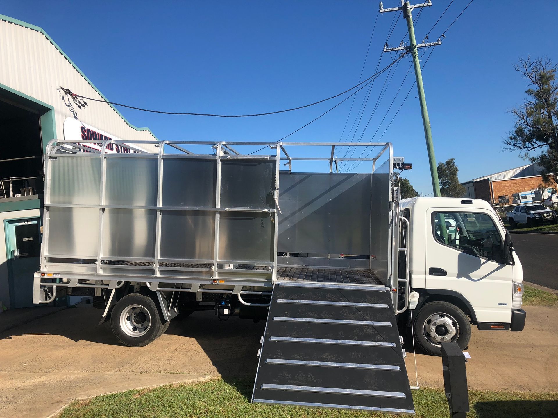 White Truck With Metal Livestock Enclosure And Ramp — Soward Steel & Aluminium Fabrication in Kyogle, NSW