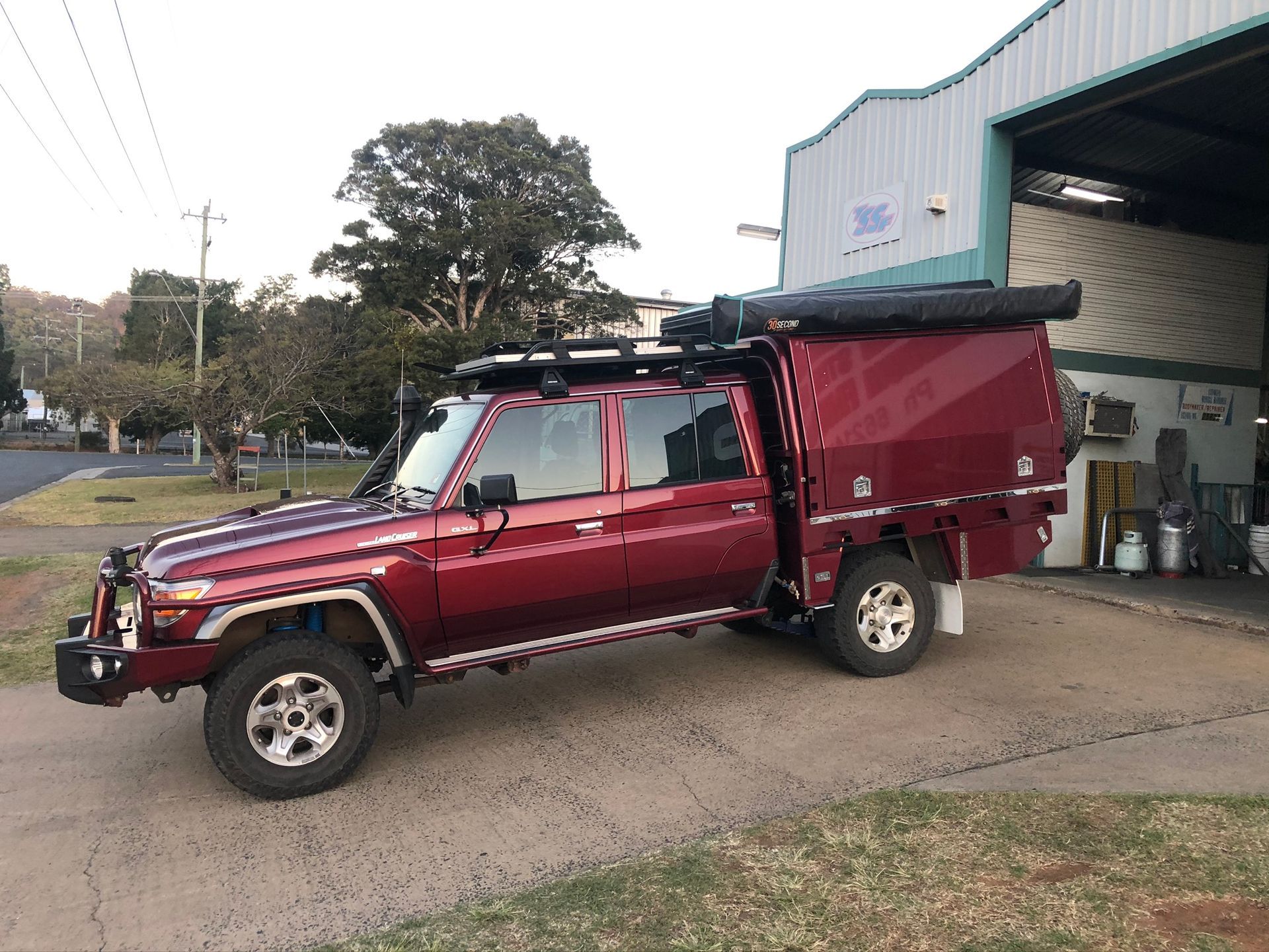 Red Pickup Truck With Camper Shell, Awning, And Roof Rack — Soward Steel & Aluminium Fabrication in South Lismore, NSW