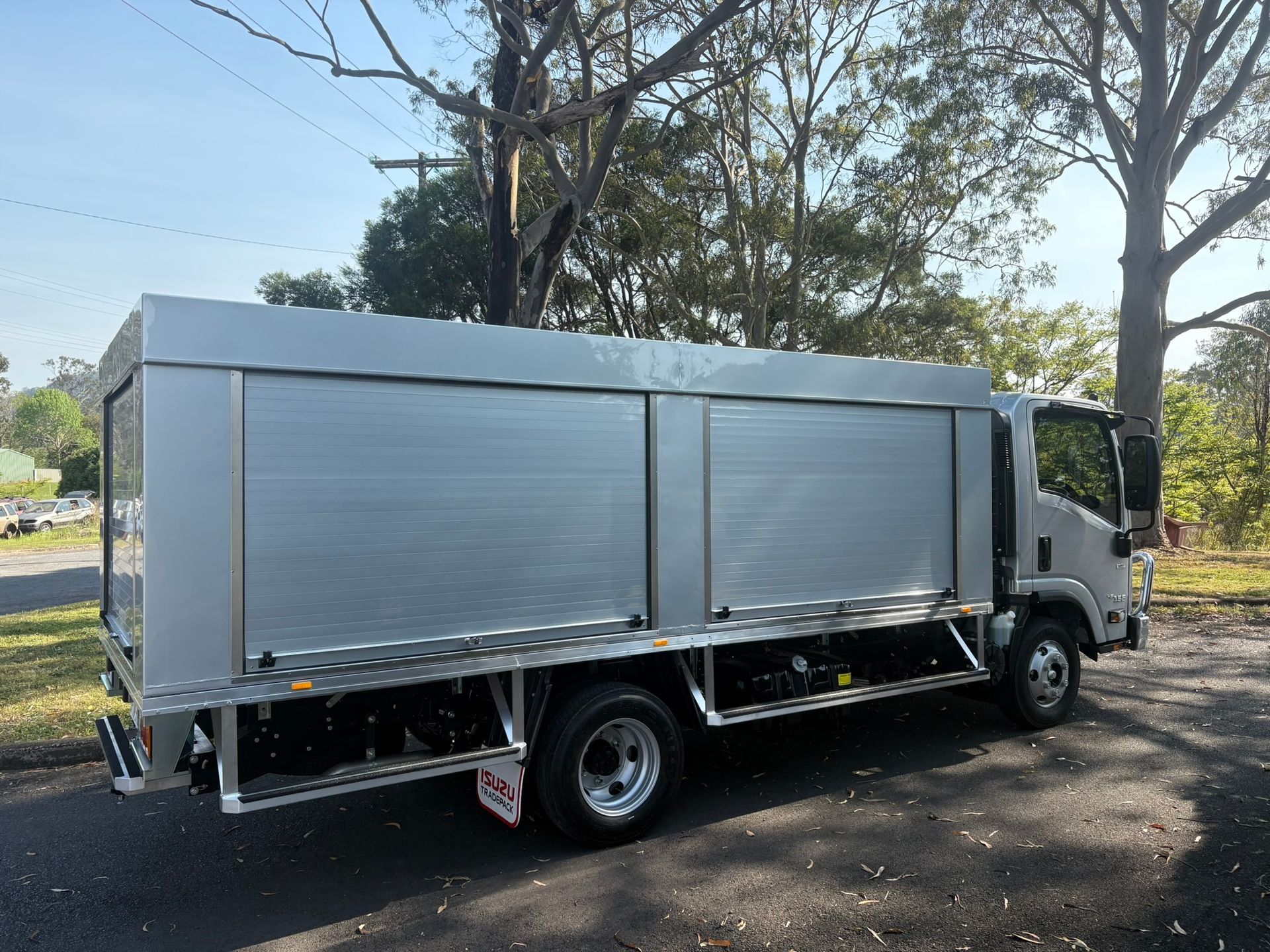 Silver Utility Truck With Roll-up Doors Parked On Asphalt — Soward Steel & Aluminium Fabrication in South Lismore, NSW