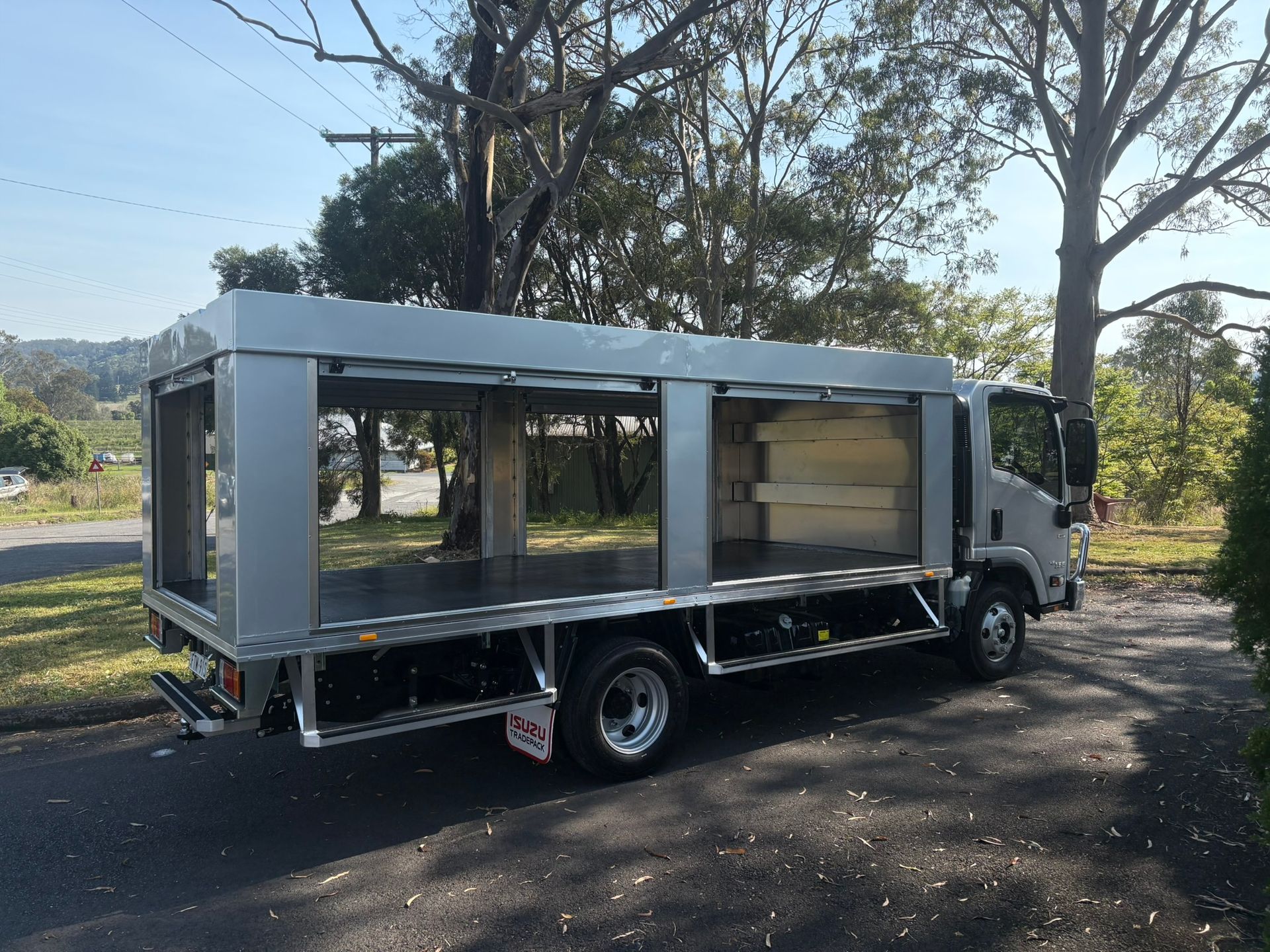 Aluminum Truck With Open Sides, Parked On A Residential Street — Soward Steel & Aluminium Fabrication in South Lismore, NSW