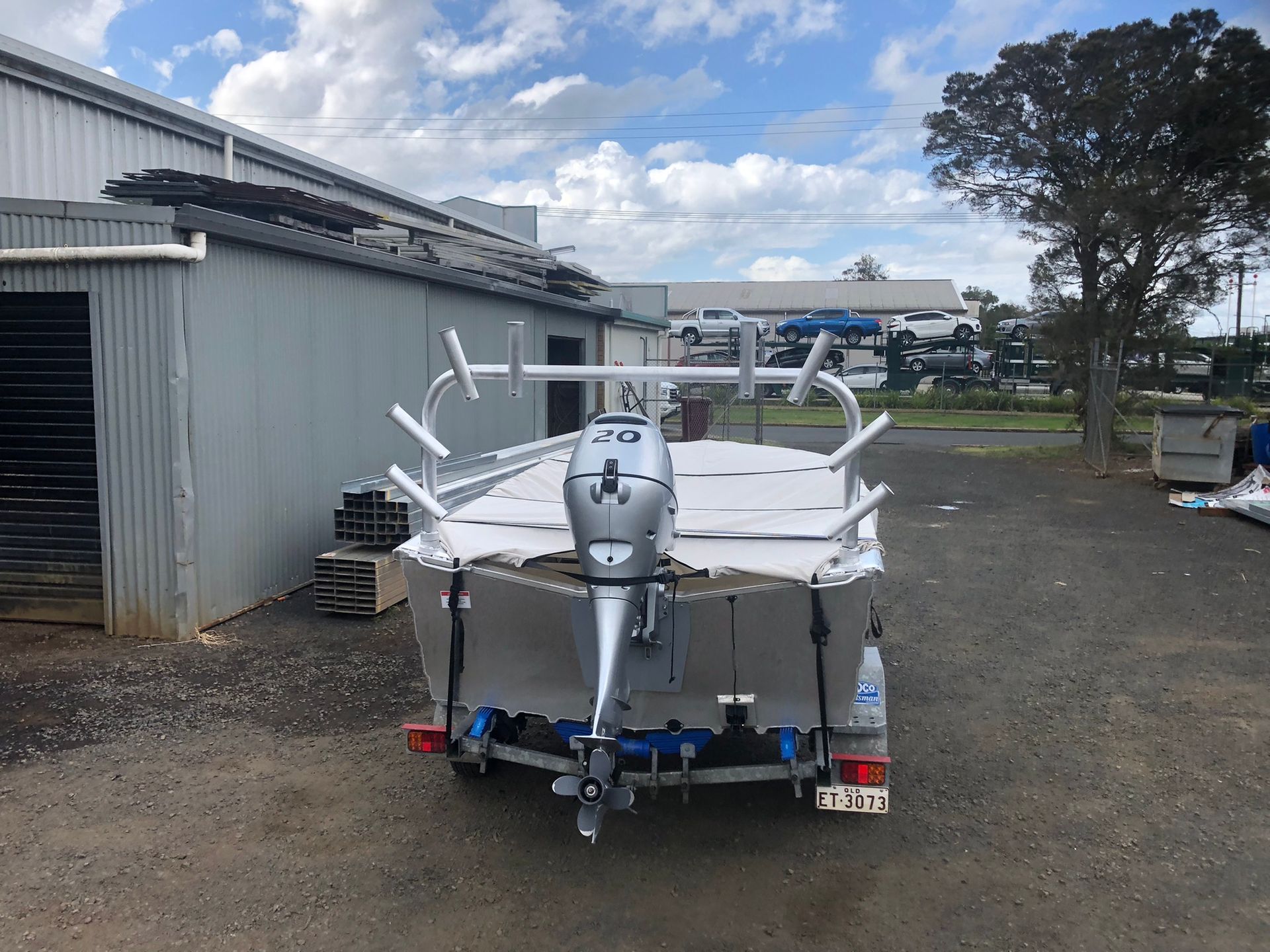 Aluminum Fishing Boat On A Trailer, Parked Outside A Warehouse — Soward Steel & Aluminium Fabrication in South Lismore, NSW