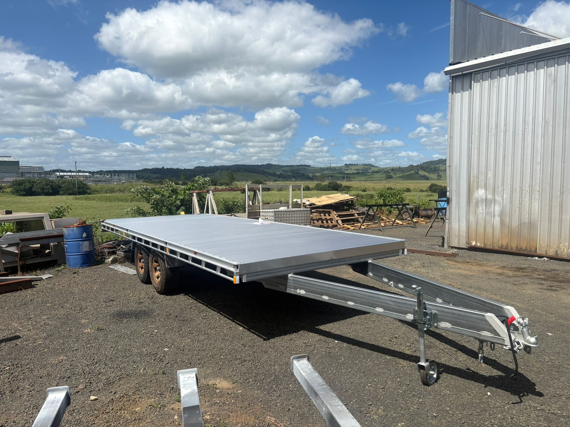 A Flatbed Trailer Parked On Gravel Outside — Soward Steel & Aluminium Fabrication in South Lismore, NSW