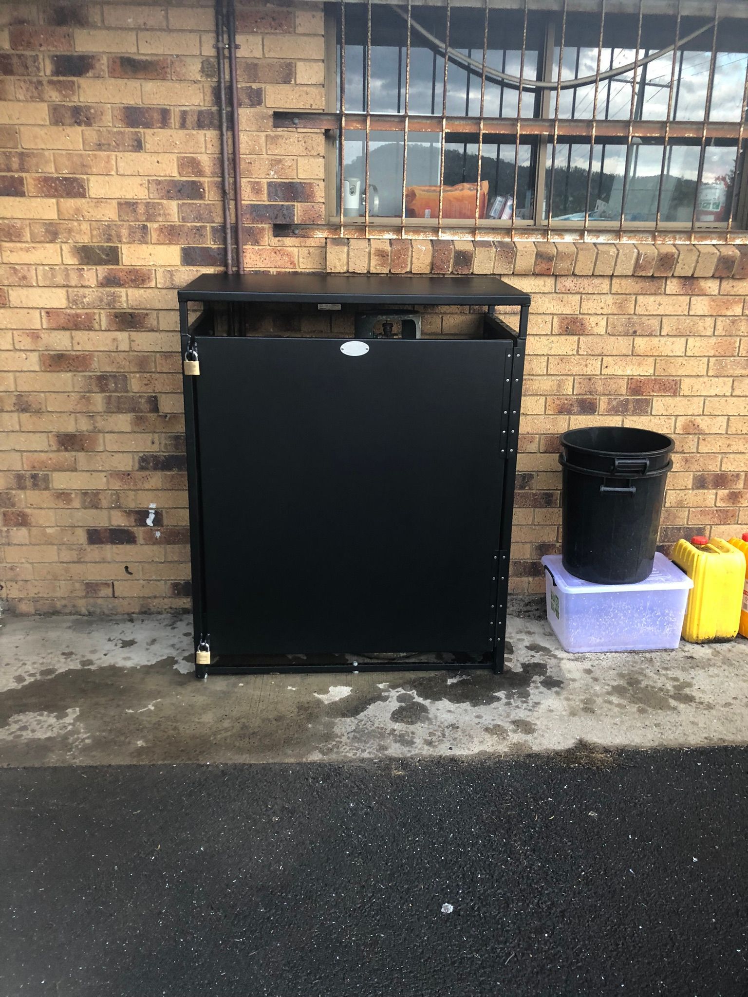 Metal Cabinet And Trash Bin Next To A Brick Wall And Window — Soward Steel & Aluminium Fabrication in South Lismore, NSW