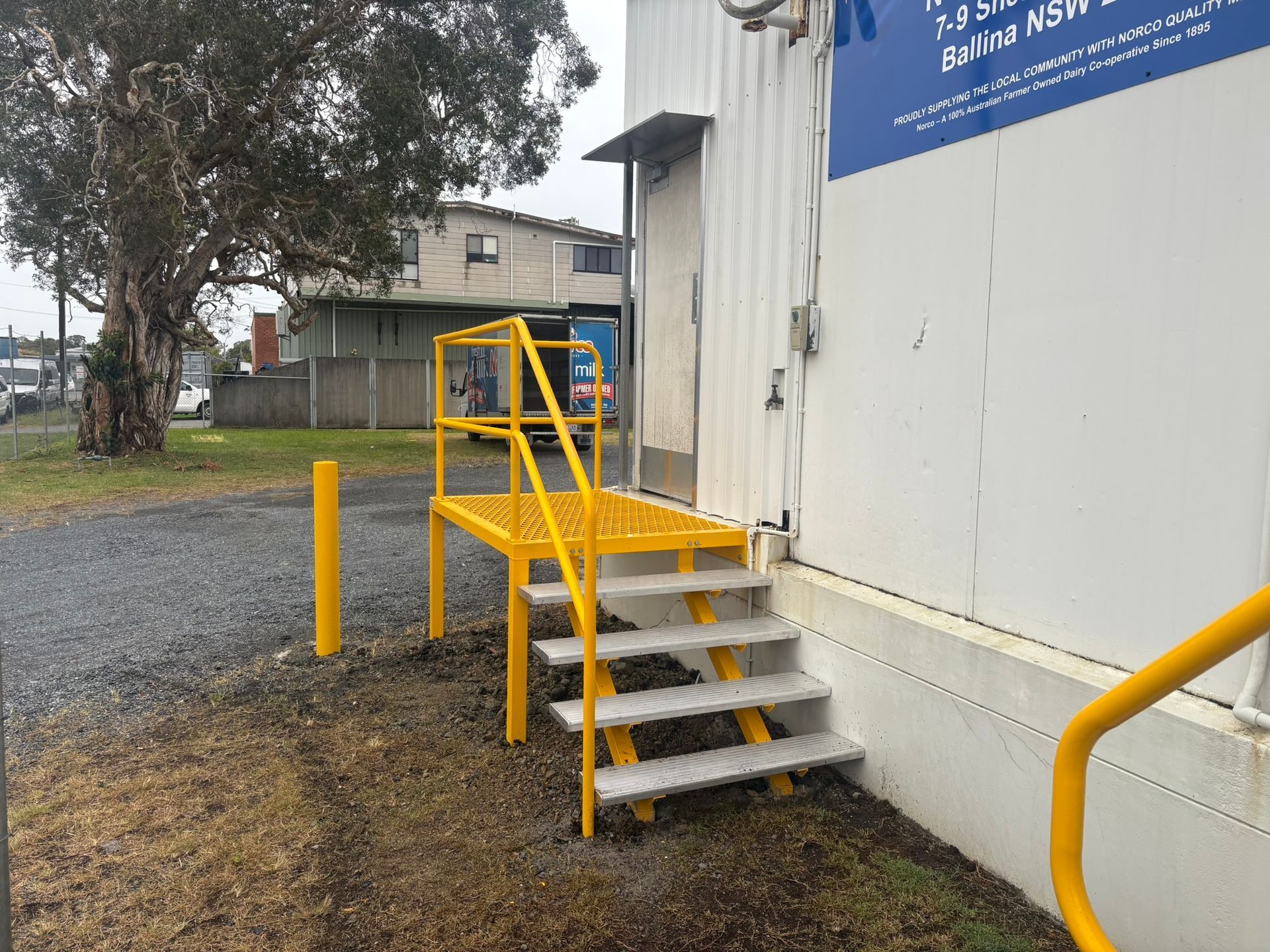 Metal Steps With Handrails Leading To A Building Door — Soward Steel & Aluminium Fabrication in South Lismore, NSW
