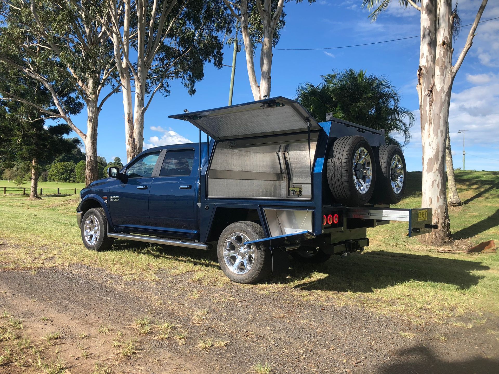 Pickup Truck With A Flatbed And Canopy On A Grassy Area — Soward Steel & Aluminium Fabrication in South Lismore, NSW