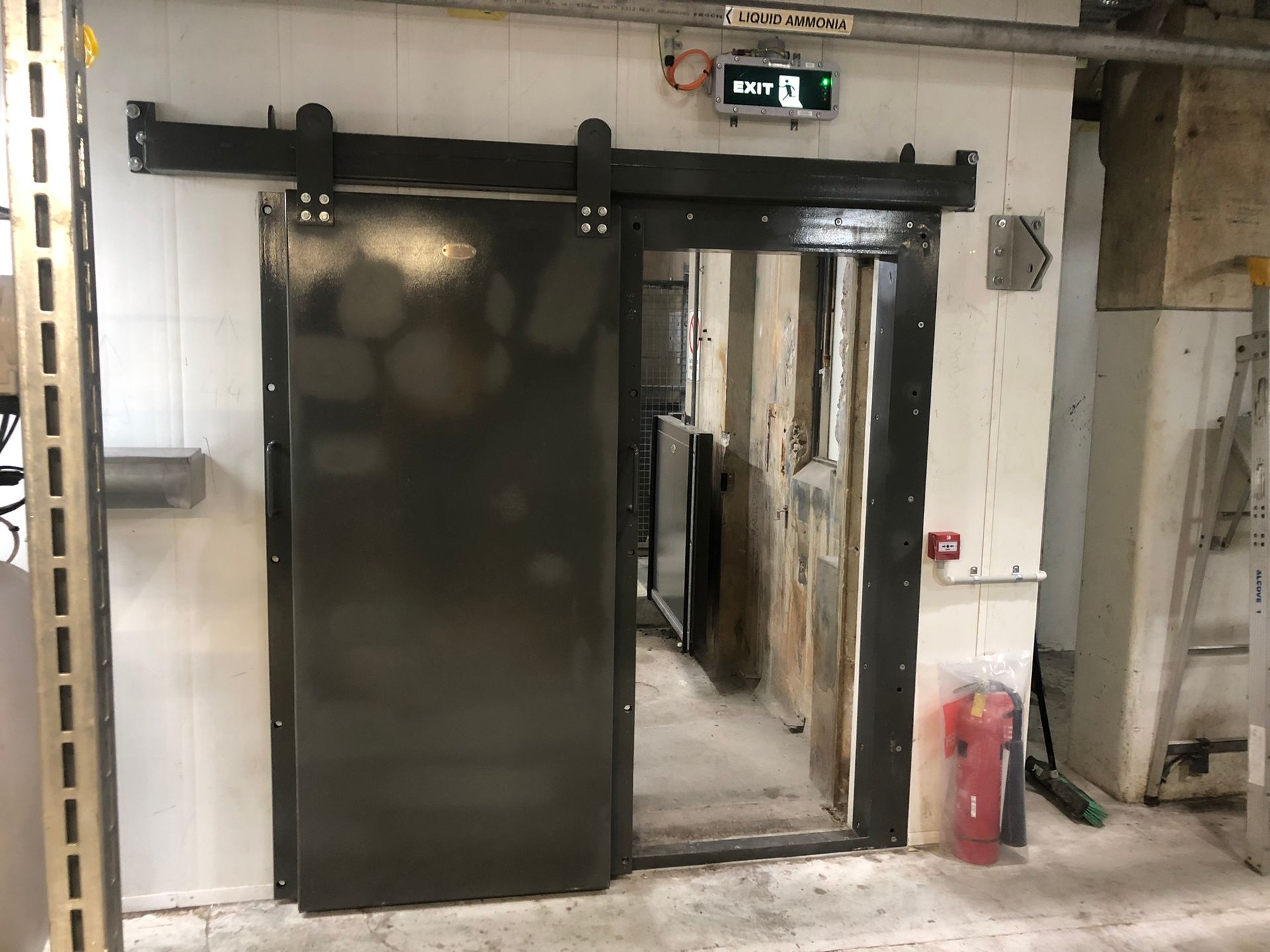 Black Sliding Metal Door In A White-walled Room — Soward Steel & Aluminium Fabrication in South Lismore, NSW