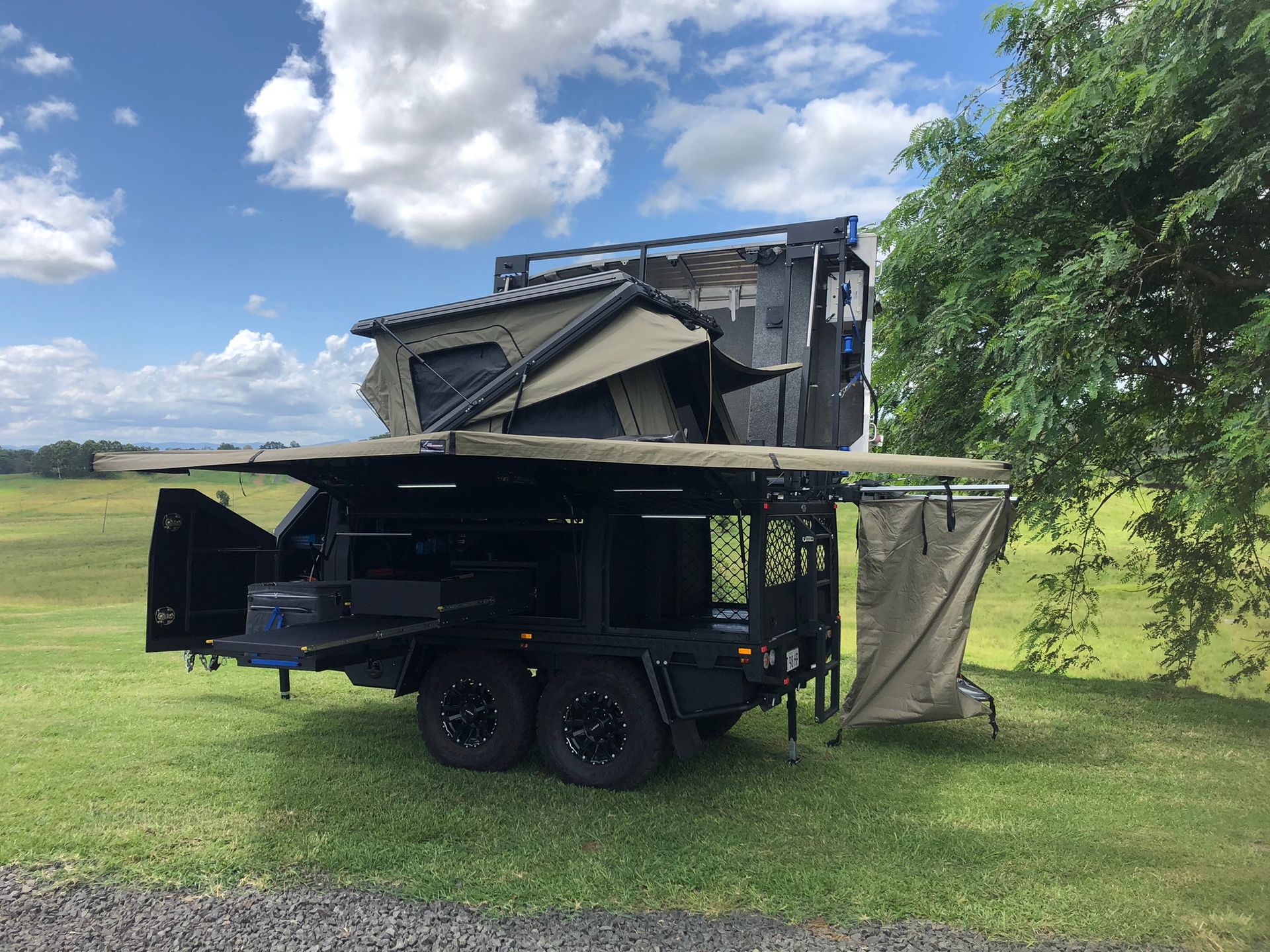 Black Off-road Camping Trailer on Green Grass — Soward Steel & Aluminium Fabrication in South Lismore, NSW
