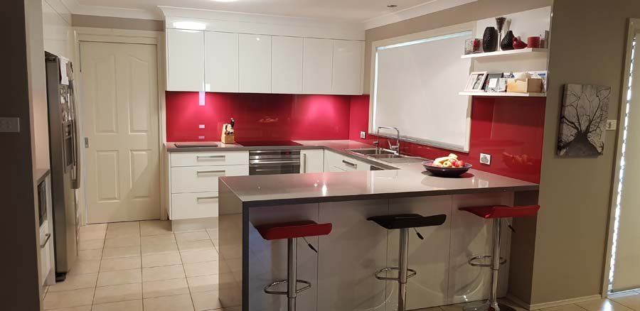 contemporary kitchen with red backsplash