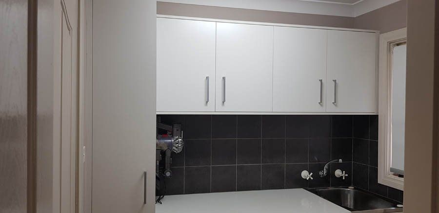 white cabinets and dark backsplash