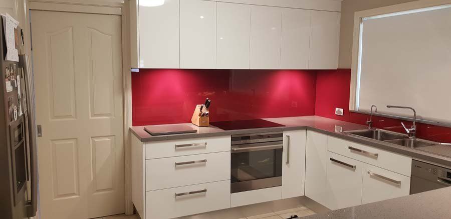 contemporary kitchen with red wall accents