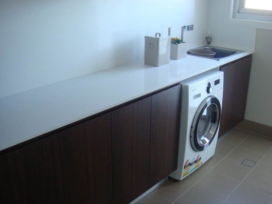 laundry room with dark cabinets