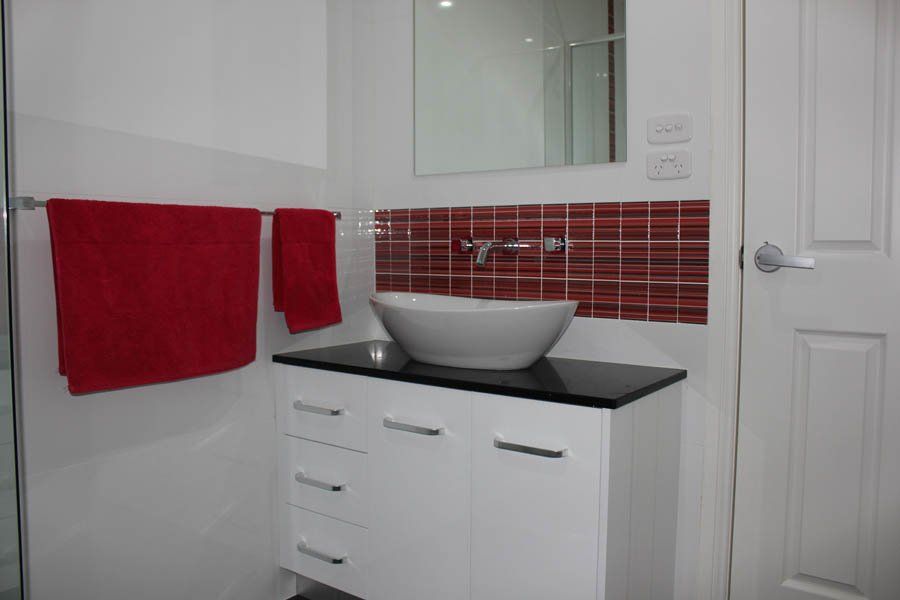 bathroom vanity sink with red accents