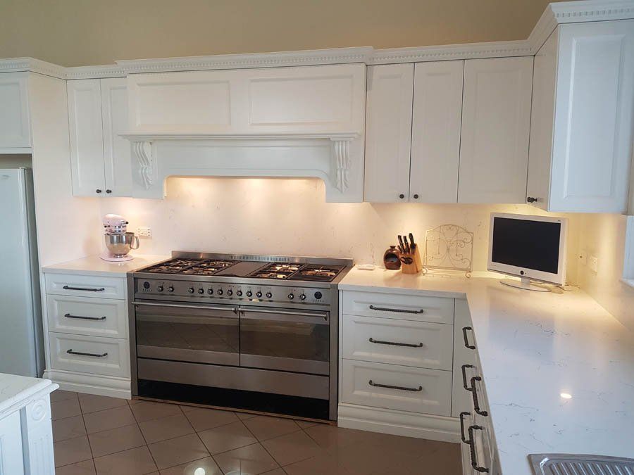 french provincial oven range and white cupboards