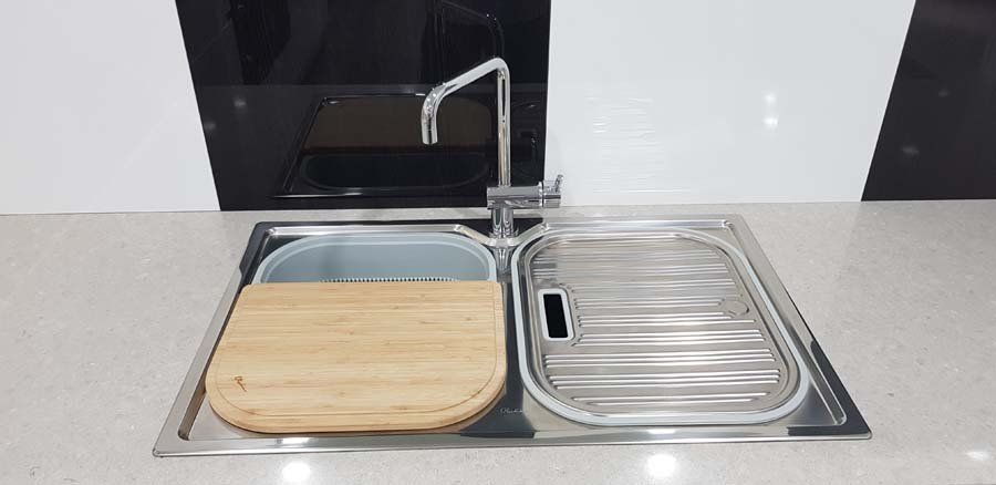 kitchen sink with cutting board and cover
