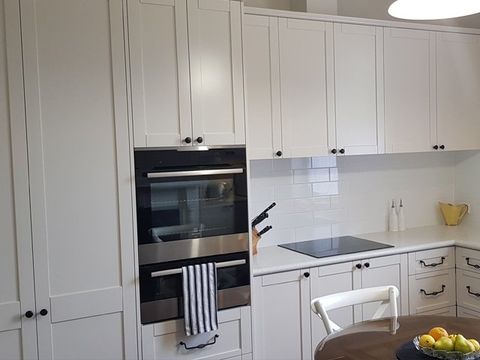 white cabinets and glass covered doors