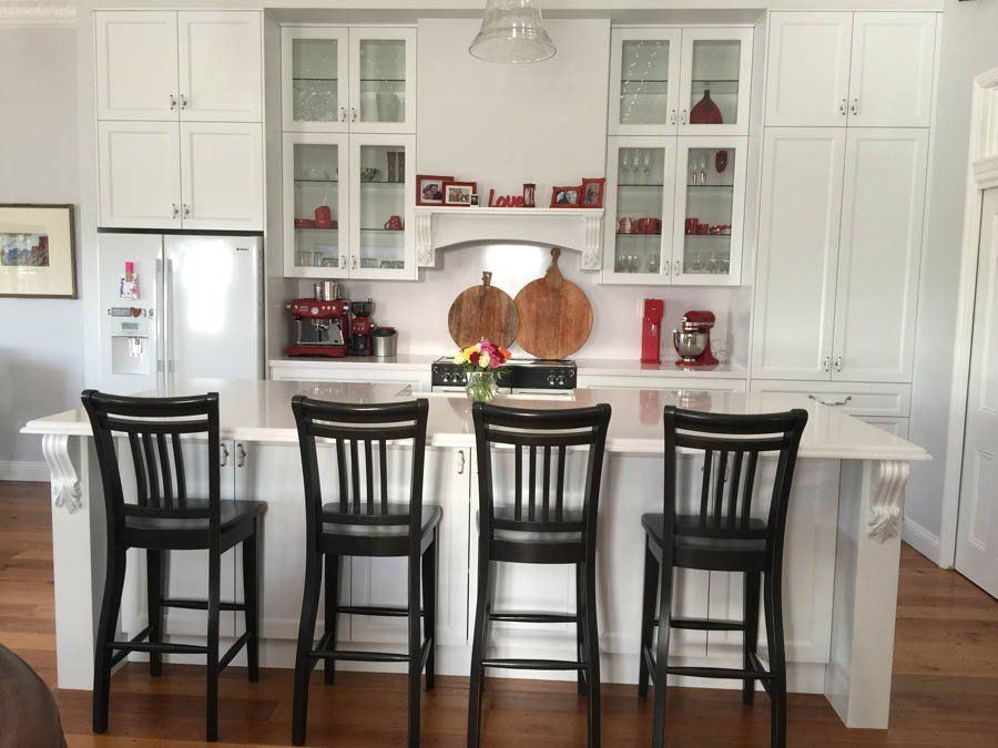 traditional kitchen with dark chairs