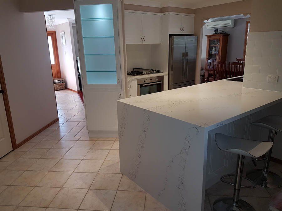 traditional kitchen island with large stone counter top