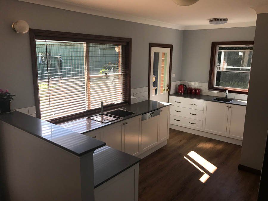 traditional kitchen counters with dark stone tops