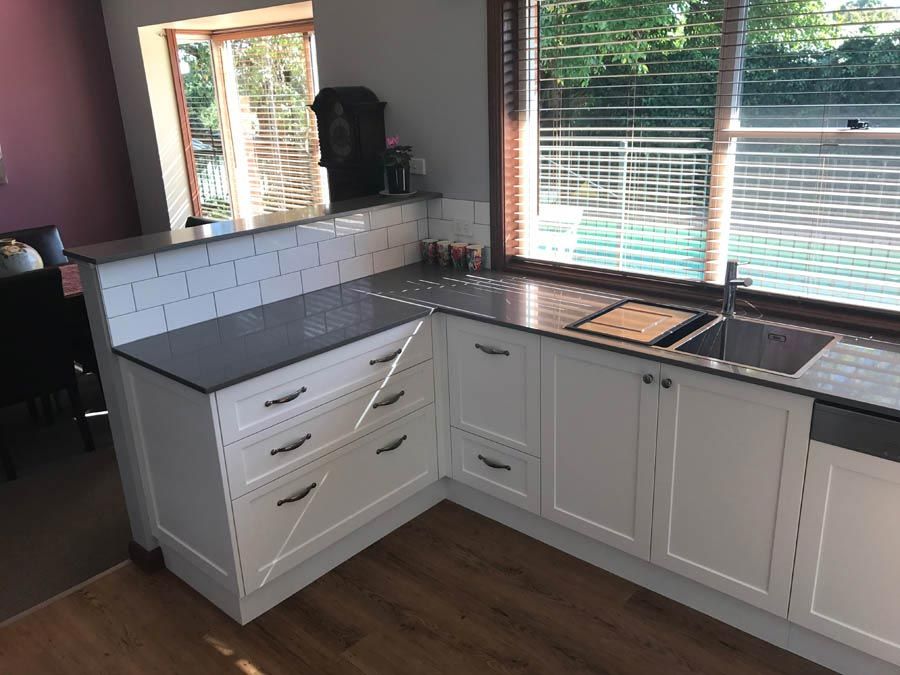 traditional kitchen counters with tiled back splash