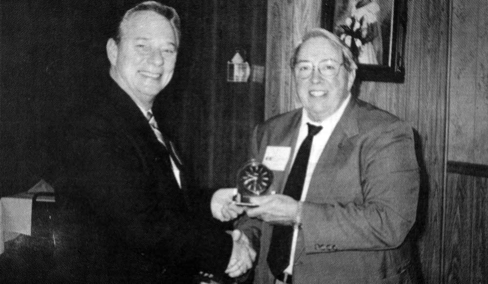 A black and white photo of two men shaking hands