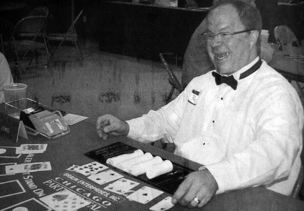 A man in a tuxedo is playing a game of poker