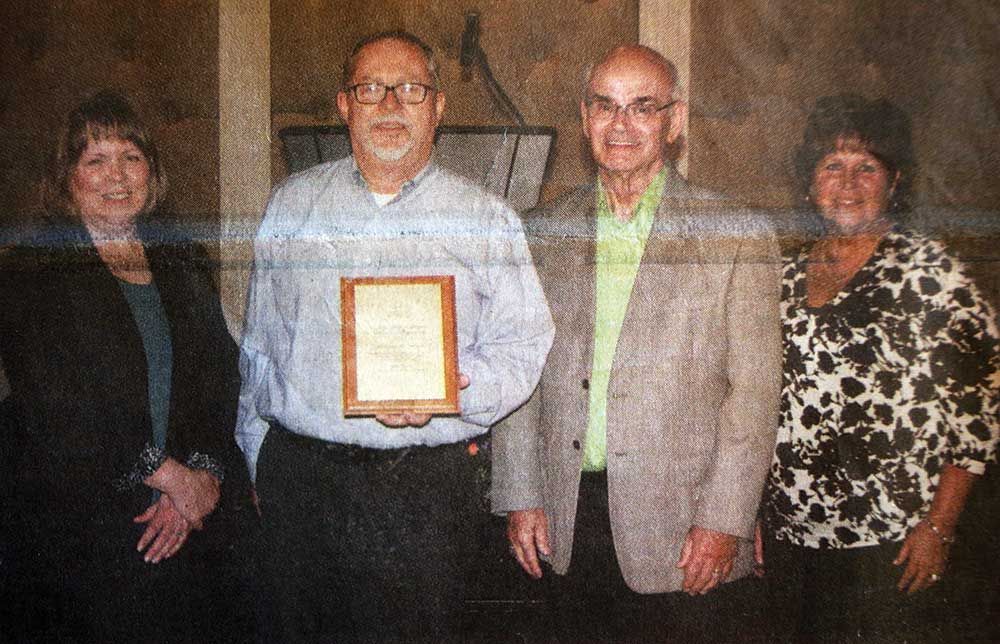 A group of people standing next to each other holding a certificate.