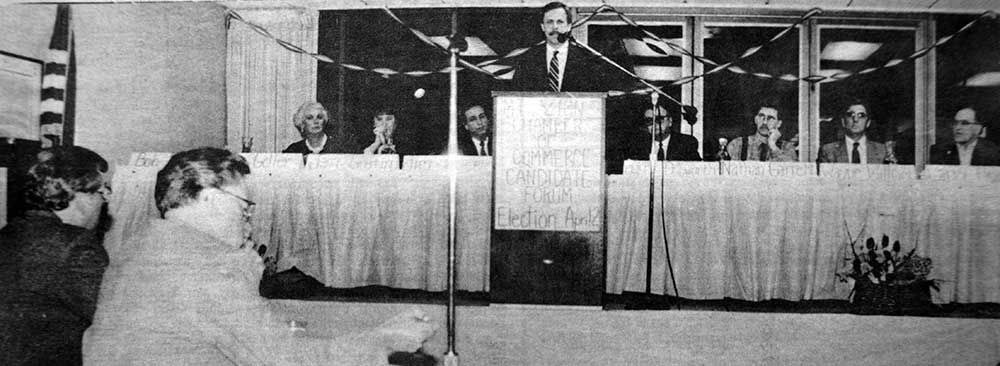 A black and white photo of a man giving a speech