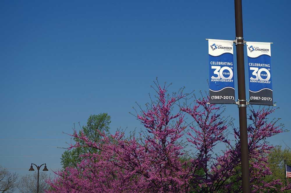 Two banners hanging from a pole with the number 30 on them