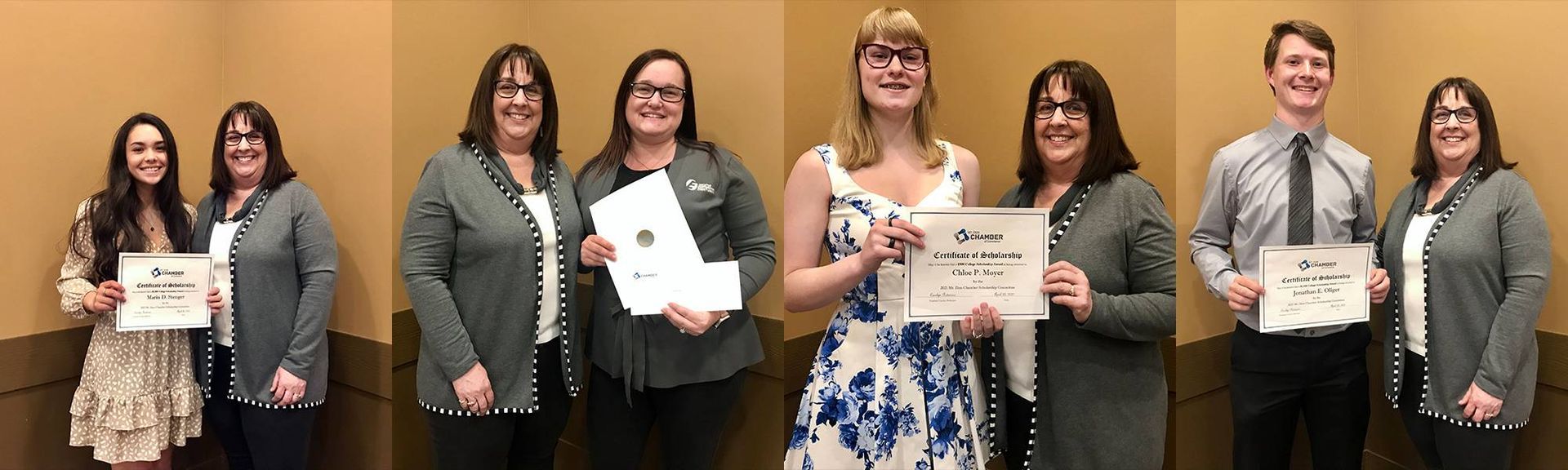 A group of people are standing next to each other holding certificates.