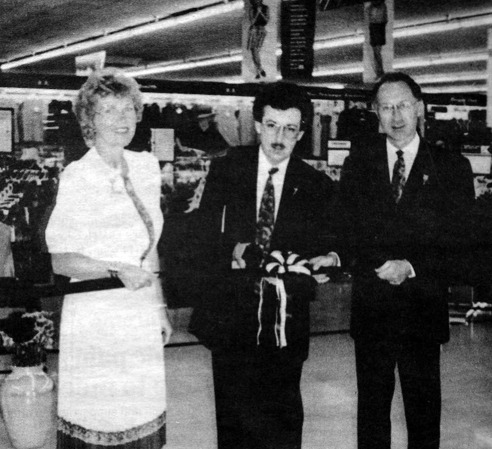 A black and white photo of three people in a store